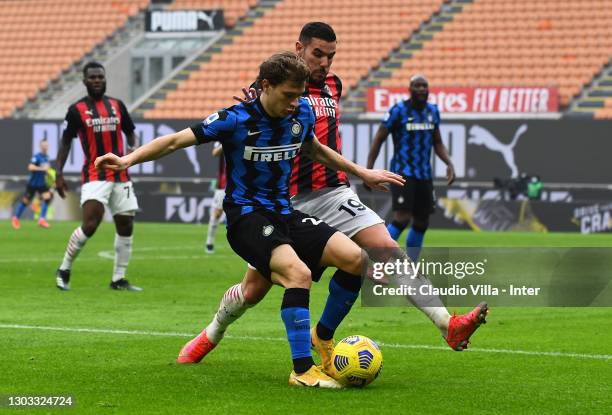 Nicolo Barella of FC Internazionale competes for the ball with Theo Hernandez of AC Milan during the Serie A match between AC Milan and FC...