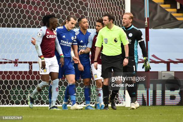 Kasper Schmeichel of Leicester City reacts after Bertrand Traore of Aston Villa scores his team's first goal during the Premier League match between...