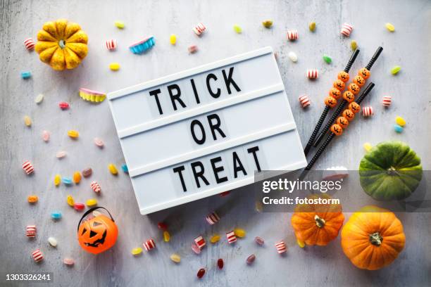 explosion of halloween candy, gourds and ''trick or treat'' message on a letter board - halloween craft stock pictures, royalty-free photos & images