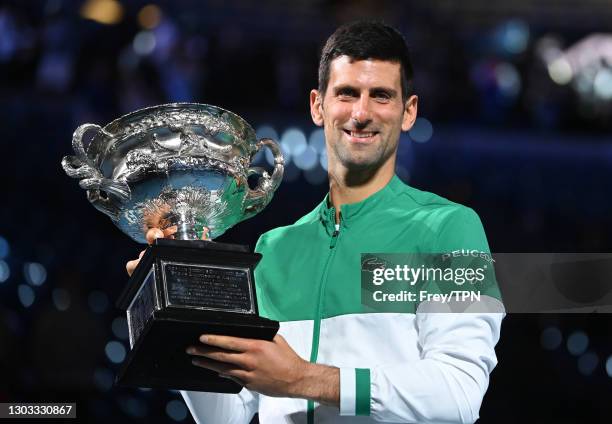 Novak Djokovic of Serbia celebrates with the trophy after beating Daniil Medvedev of Russia in the men's singles final during day 14 of the 2021...