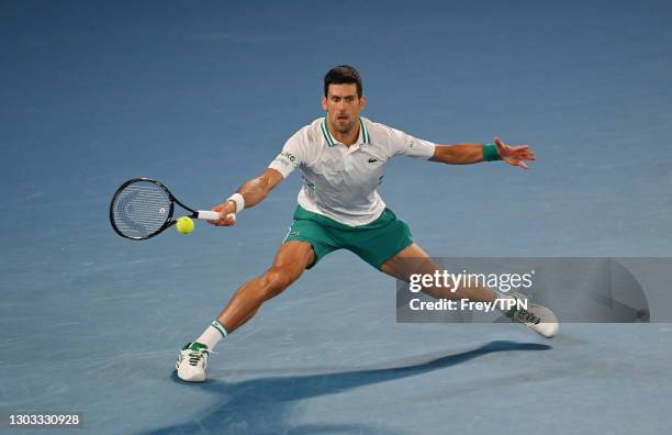 Novak Djokovic of Serbia hits a forehand against Daniil Medvedev of Russia in the men's singles final during day 14 of the 2021 Australian Open at...