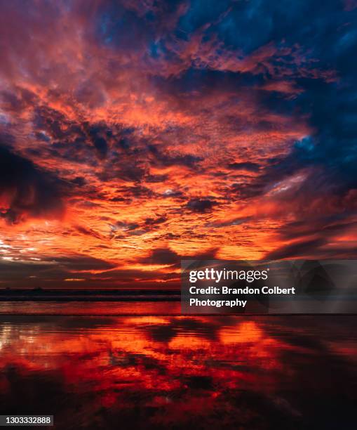 wild ocean sunset. - dramatic sky red stock pictures, royalty-free photos & images