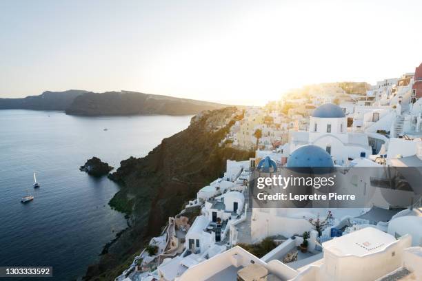 oia at sunset (three blue domes), santorini (santorin), greece - mediterranean-blue-roof-santorini stock pictures, royalty-free photos & images