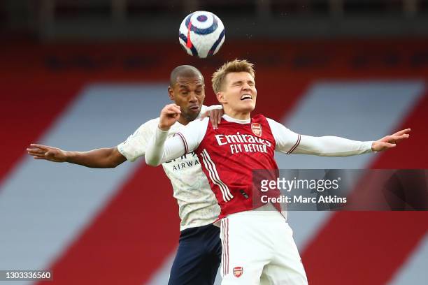 Fernandinho of Manchester City competes for a header with Martin Odegaard of Arsenal during the Premier League match between Arsenal and Manchester...