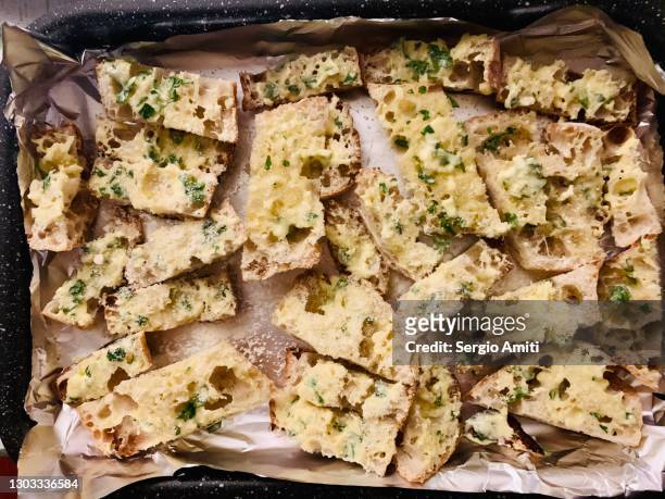 preparing homemade garlic bread - garlic bread stock pictures, royalty-free photos & images