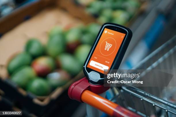 grocery shopping with a smart handset - checkout screen stock pictures, royalty-free photos & images