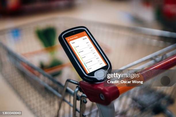 grocery shopping with a smart handset - counter intelligence stock pictures, royalty-free photos & images