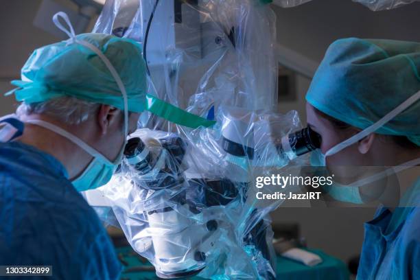 mikrochirurgie mit op-roboter - neurosurgery stock-fotos und bilder
