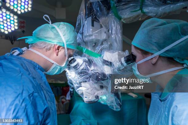 micro surgery with surgery robot - neurosurgery concept stock pictures, royalty-free photos & images