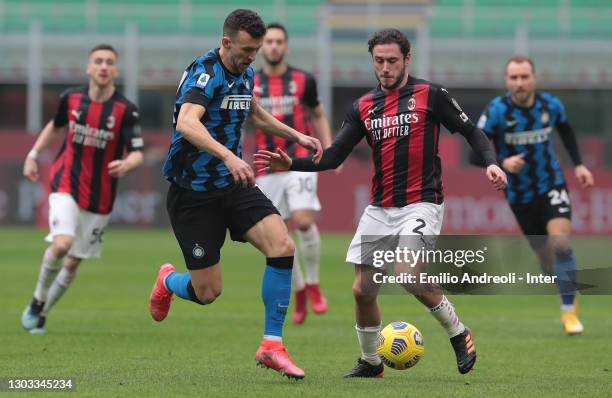 Ivan Perisic of FC Internazionale is challenged by Davide Calabria of AC Milan during the Serie A match between AC Milan and FC Internazionale at...