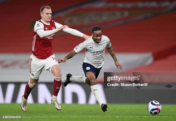 Raheem Sterling of Manchester City is tackled by Rob Holding of Arsenal during the Premier League match between Arsenal and Manchester City at...