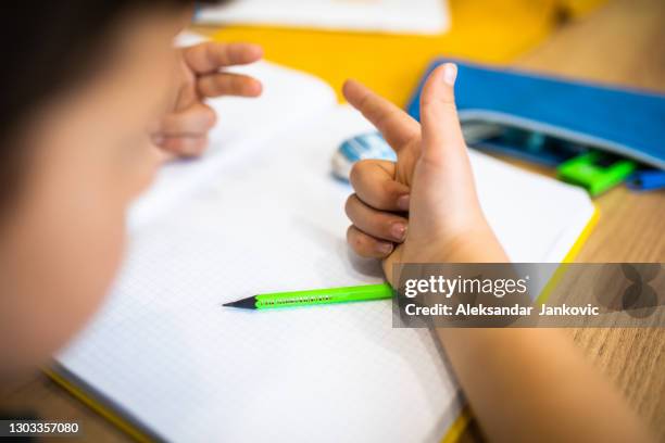 a boy adding numbers with his fingers - counting stock pictures, royalty-free photos & images