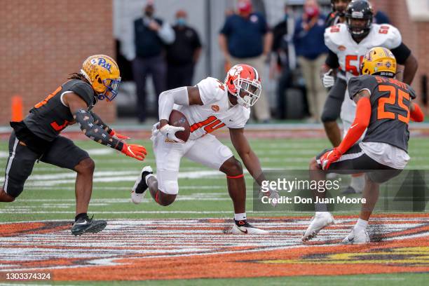 Wide Receiver Cornell Powell from Clemson of the American Team avoids being tackled by Safety Damar Hamlin from Pittsburgh and Cornerback Benjamin...