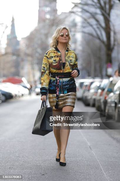 German TV host Carola Ferstl wearing black pumps by Buffalo, a silver and gold striped sequin mini skirt by Max Mara, a black top by Armani,...