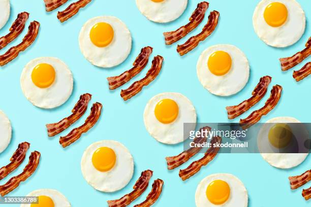 bacon and eggs pop art on a bright light blue background - bacon stock pictures, royalty-free photos & images