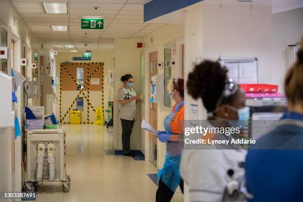 Medical staff stand outside rooms of suspected COVID patients in the A&E at the University Hospital Coventry on May 25, 2020 in Coventry, United...