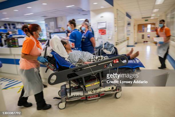 Medical staff transporting a new suspected COVID-19 patient, Ranghbir Hayer, through COVID-19 ward at University Hospital Coventry on May 25, 2020 in...