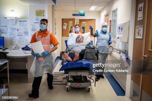 Medical staff Tahmid Chowdhury 22, and Helen Conkleton 41, transporting Ranghbir Hayer through the A&E section of the ward reserved for suspected...