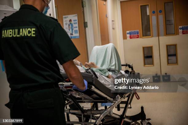 Paramedics carrying elderly woman through University Hospital Coventry ward to be returned back to her nursing home on May 25, 2020 in Coventry,...