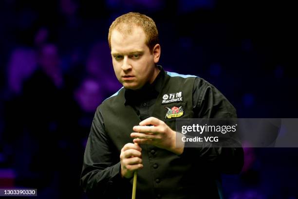 Jordan Brown of Northern Ireland chalks stick during his first round match against Neil Robertson of Australia during 2019 Welsh Open on February 12,...