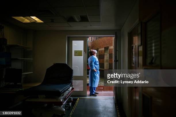 Domestic caretaker Jim Johnson takes a breath of fresh air and feels the rain on his face outside the paramedic's entrance of the triage area in the...