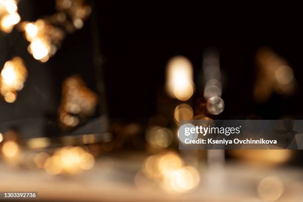 image of wooden table in front of abstract blurred background of resturant lights - black wood stockfoto's en -beelden