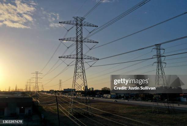 View of high voltage transmission towers on February 21, 2021 in Houston, Texas. Millions of Texans lost power when winter storm Uri hit the state...