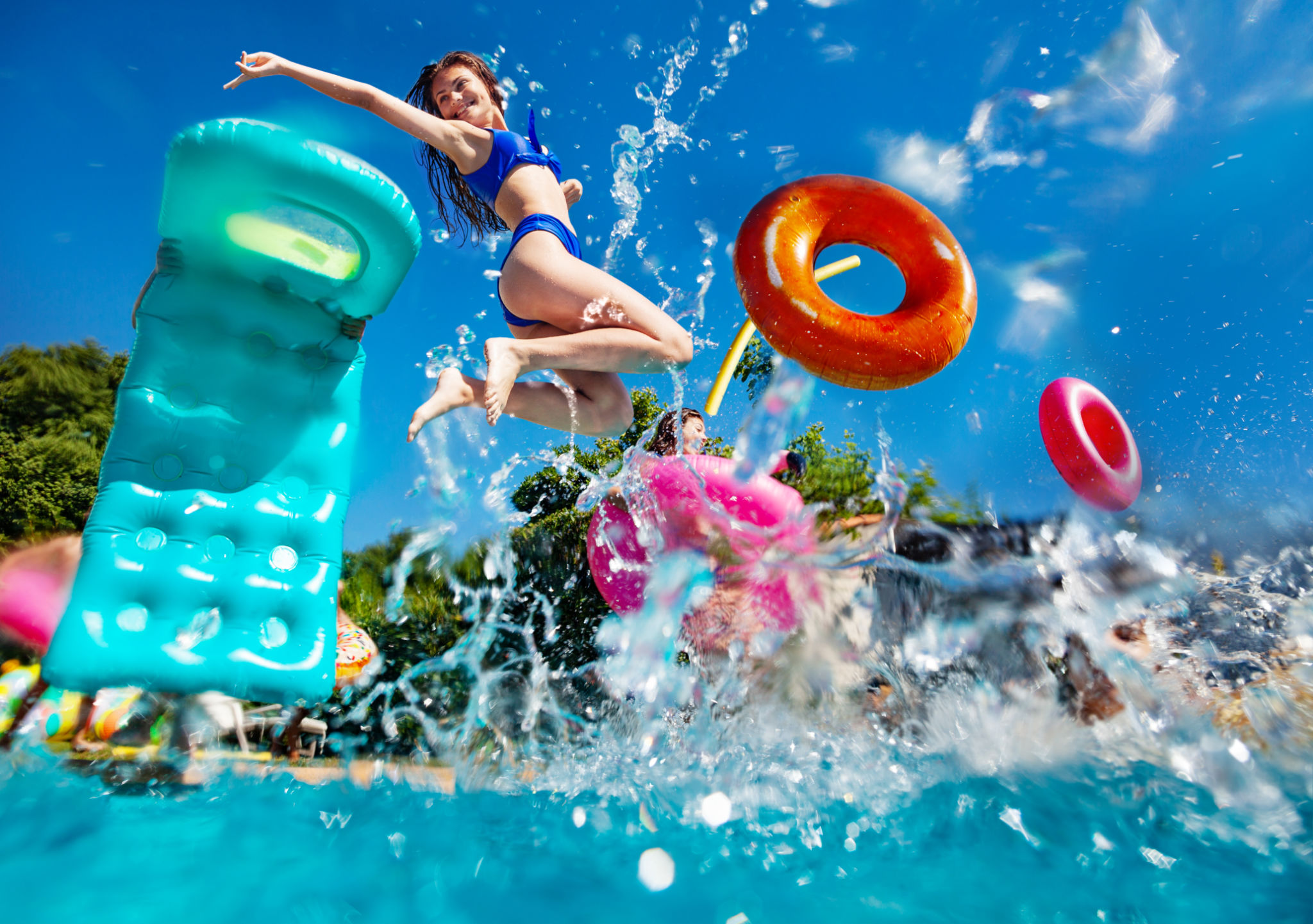 Girl and friends dive in swim pool splash to water Girl and friends dive in swim pool splash to water