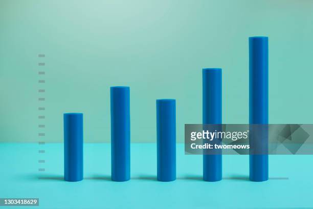 abstract ascending blue tubes on blue background still life. - bar graph stock pictures, royalty-free photos & images