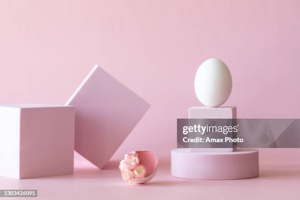 happy easter greeting card. pink podium, stand with white egg. - easter background stock pictures, royalty-free photos & images