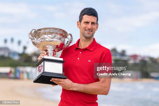 Novak Djokovic of Serbia poses with the Norman Brookes Challenge Cup after winning the 2021 Australian Open Men's Final, at Brighton Beach on...