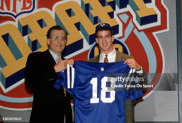 First round draft pick Peyton Manning of the Indianapolis colts and Commissioner Paul Tagliabue poses for this photo while Peyton shows his jersey to...