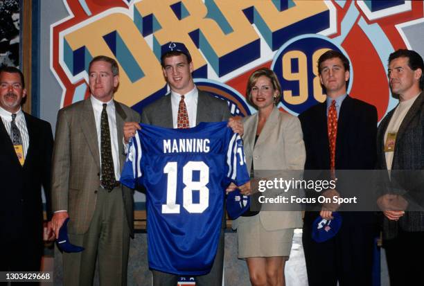 First round draft pick Peyton Manning of the Indianapolis colts poses for this photo with his family and the owner of the Colts Jim Irsay far left...