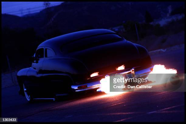 Classic car designer and builder, Dean Bryant drives his customized, flame blowing 1950 Mercury down a street June 19, 2000 in Santa Clarita, Ca....