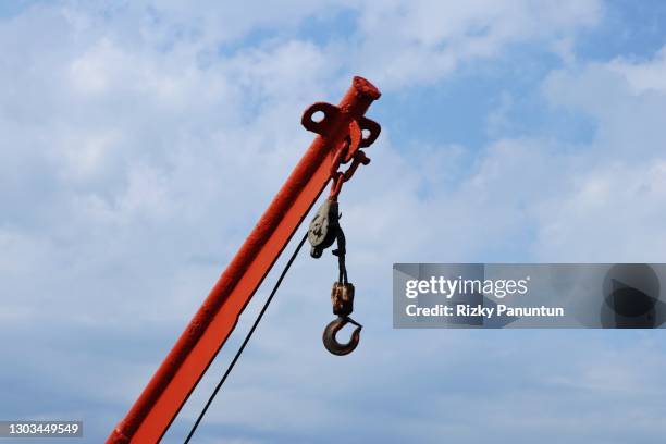 crane hook against sky - pulley stock pictures, royalty-free photos & images