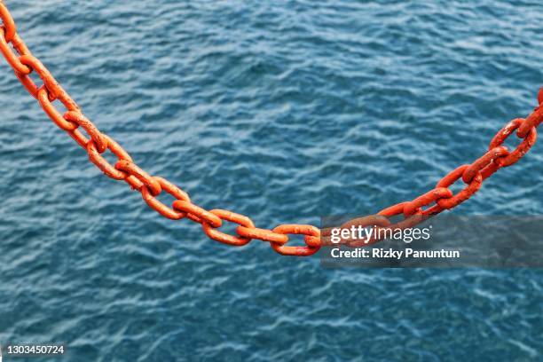 close-up of chain against sea - rusty anchor stock pictures, royalty-free photos & images