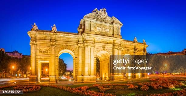 madrid puerta de alcala iconic landmark illuminated at dusk panorama spain - madrid landmark stock pictures, royalty-free photos & images