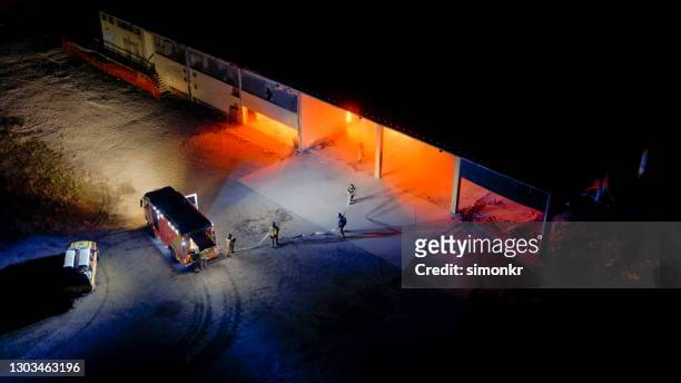 firefighters with fire engine at gas explosion - burst pipe stock pictures, royalty-free photos & images