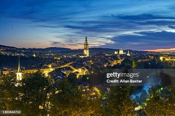 elevated view of bern illuminated at dusk - bern switzerland stock-fotos und bilder