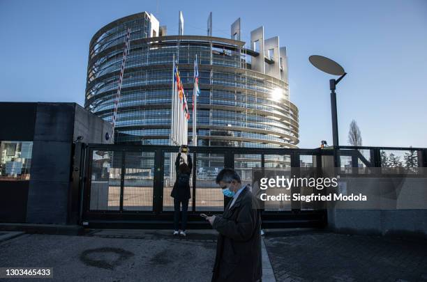 Man walks past the European Parliament building on February 21, 2021 in Strasbourg, eastern France. A year into the pandemic, the east of France...