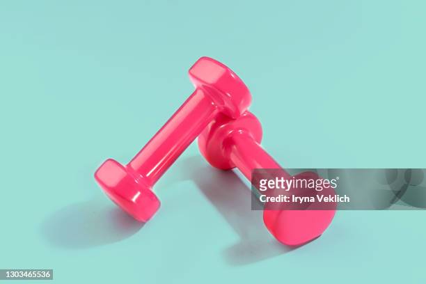 sport lifestyle concept with pink dumbbells on pastel mint green background. - dumbells isolated stock pictures, royalty-free photos & images