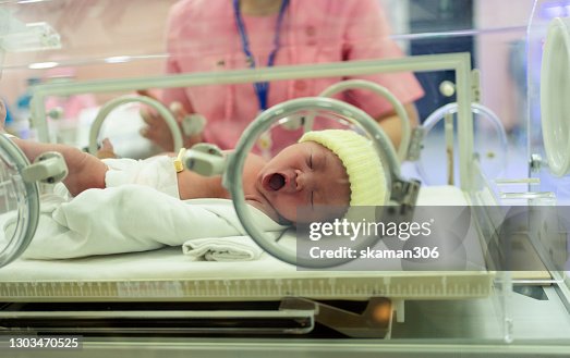 Close up face Asian newborn baby crying in an incubator first day in the world Close up face Asian newborn baby crying in an incubator first day in the world