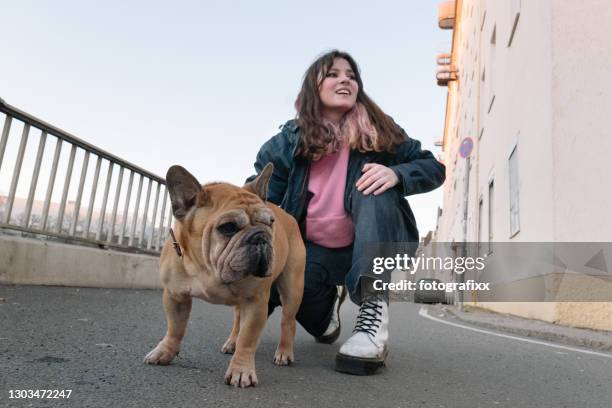 teenage girl portrait with french bulldog, urban background - little punk stock pictures, royalty-free photos & images