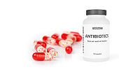 Pharmacy bottle with red pills isolated on a white