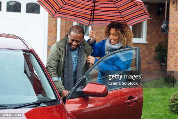 a helping hand - rain umbrella stock pictures, royalty-free photos & images