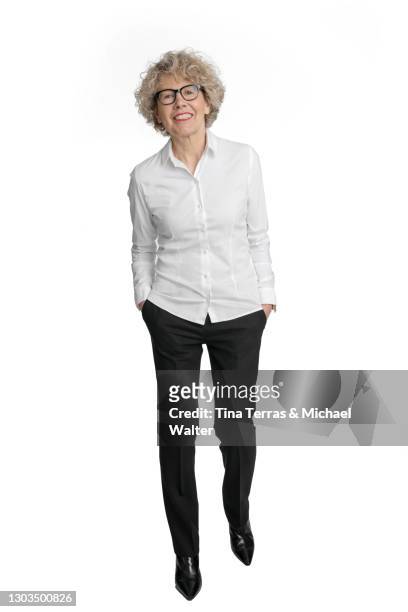 attractive senior business woman smiling at the camera, isolated on white background. - ganzkörperansicht stock-fotos und bilder