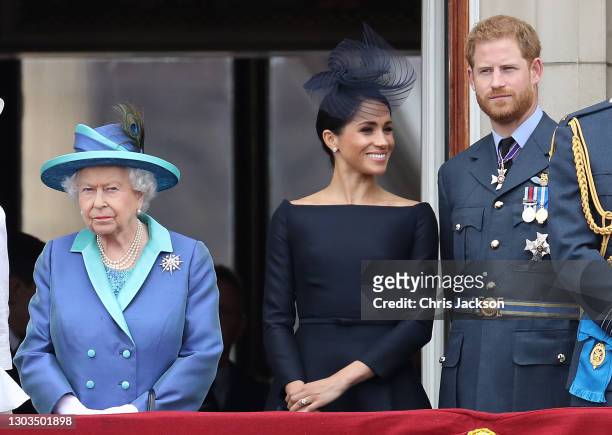 Queen Elizabeth II, Prince Harry, Duke of Sussex and Meghan, Duchess of Sussex on the balcony of Buckingham Palace as the Royal family attend events...