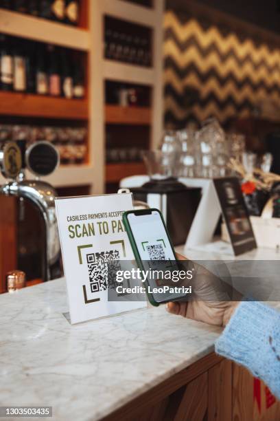 customer paying the bill using qr code on mobile phone avoiding contacts - qr code scanning stock pictures, royalty-free photos & images