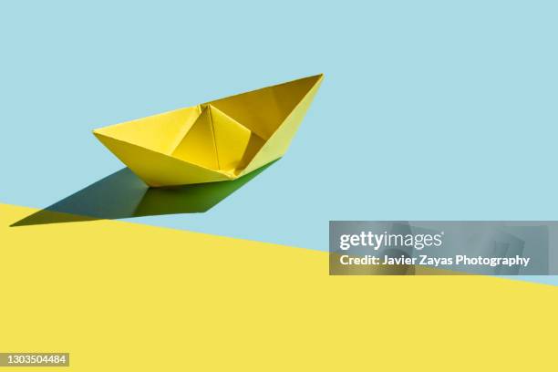 yellow paper boat - paper boat stock pictures, royalty-free photos & images