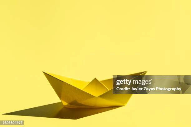 yellow paper boat - paper boat stock pictures, royalty-free photos & images